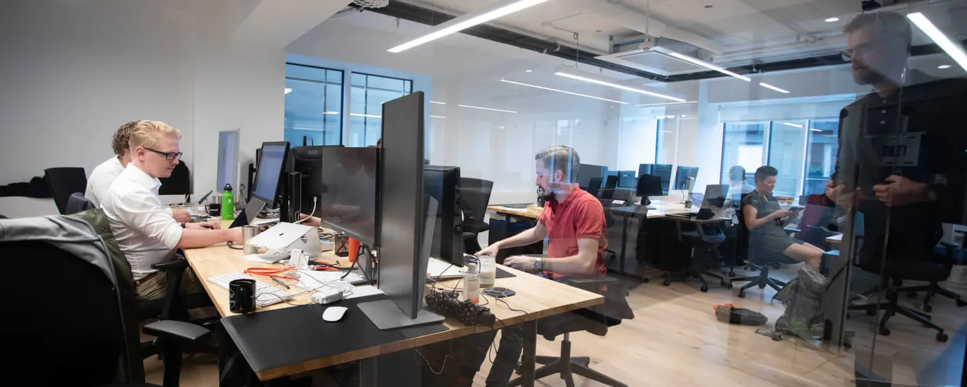 Consultants working at their desks in an open-plan office
